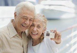 Cuplu de seniori care utilizează camera digitală la Marina